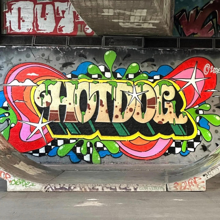 Colorful graffiti on a wall with the word 'HOTDOG' in a stylized font.