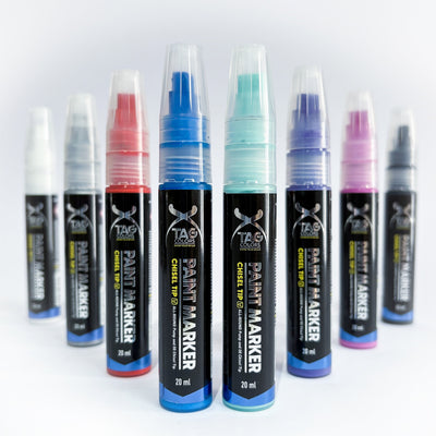 Set of paint markers with different colored caps on a white background